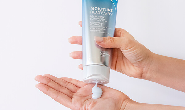 Moisture-Recovery-conditioner-in-hand Joico conditioner being poured into hand