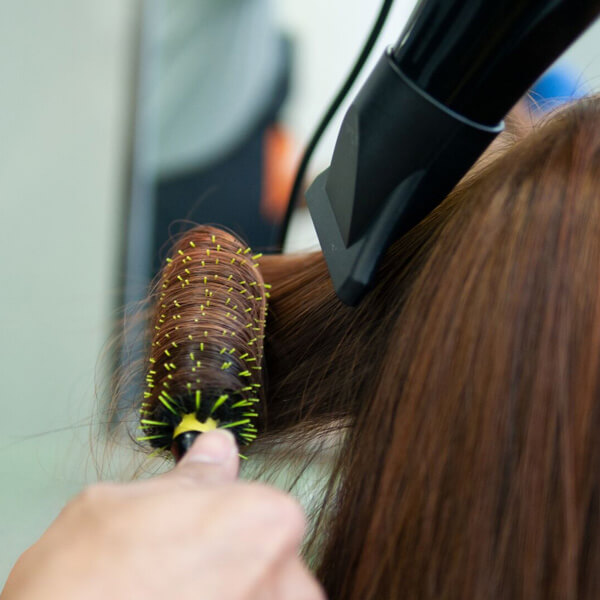 Hair being Blowdried with round brush