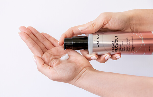 Hair styling product being coming out of bottle