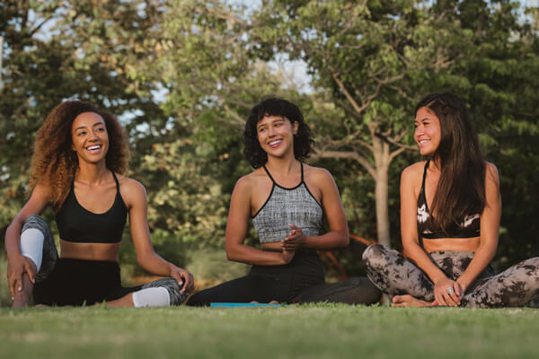 joi-blog-emotional Three women doing yoga in park