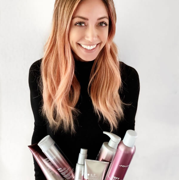 jill-take-home-defy-damage Hairstylist Jill Buck holding Defy Damage products