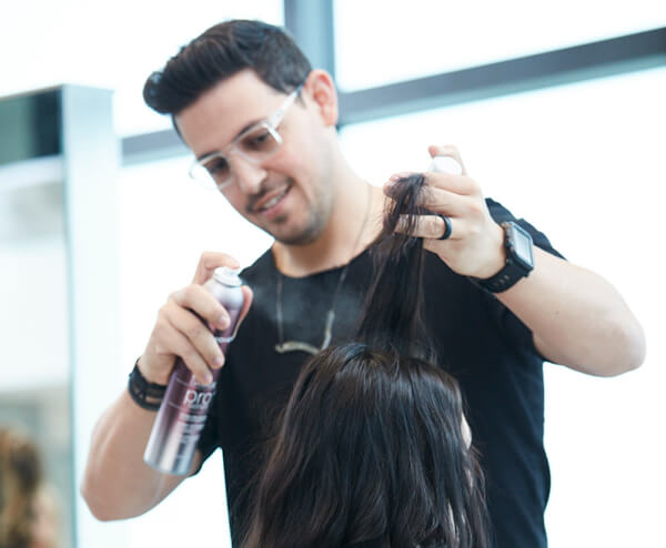 ricardo-defy-damage Stylist Ricardo Santiago prepping clients hair