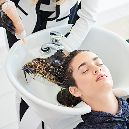 Women getting hair washed in salon