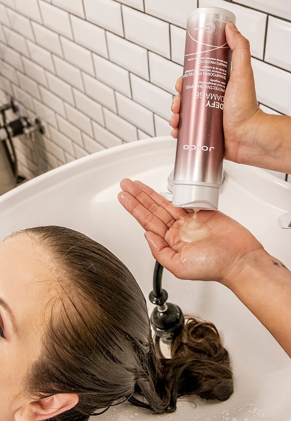defy-damage-in-salon Joico Defy Damage bottle squeezing into hand