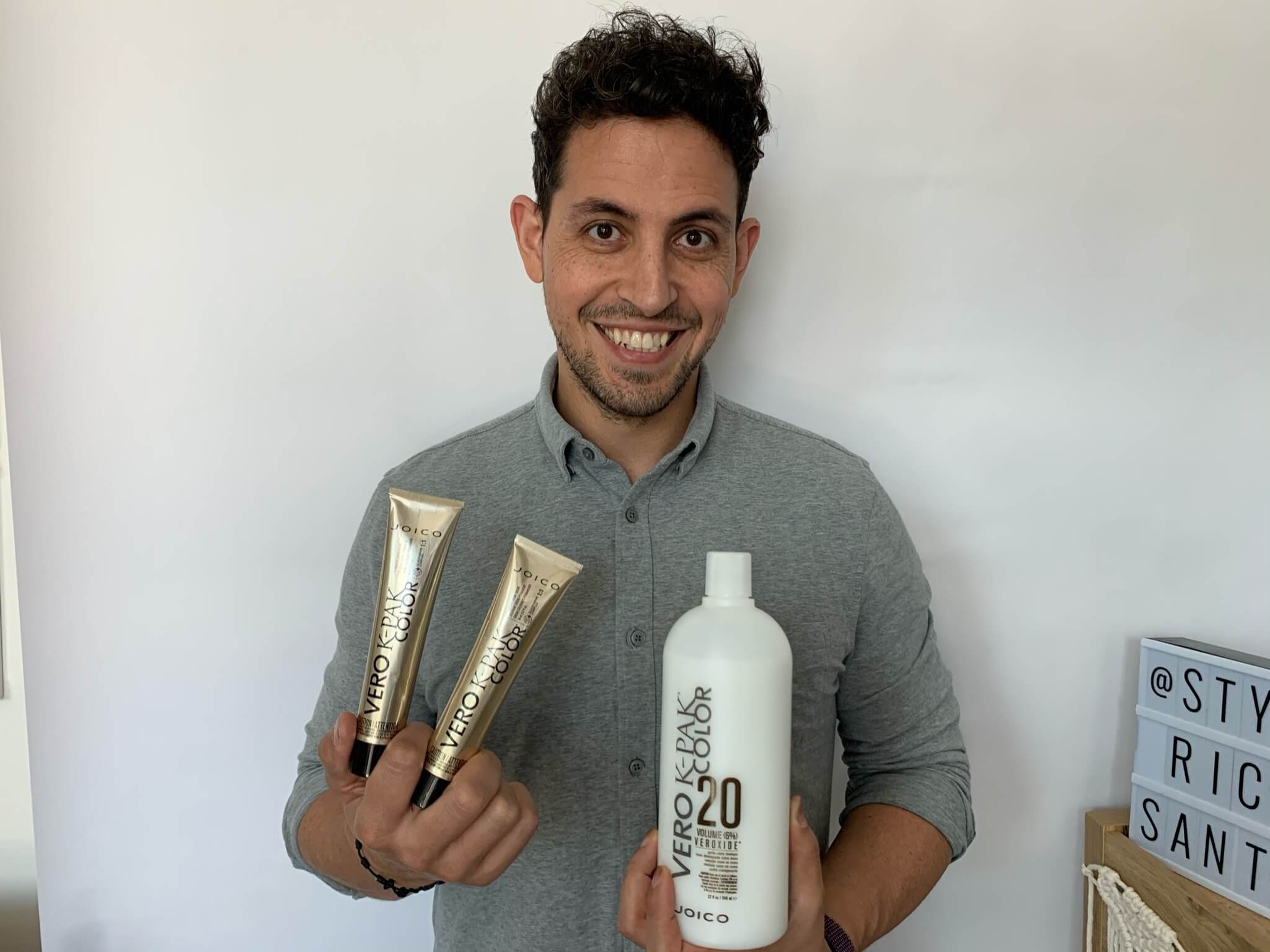 ricardo-VKCBA-Product hair Stylist holding Vero K-pak bottles