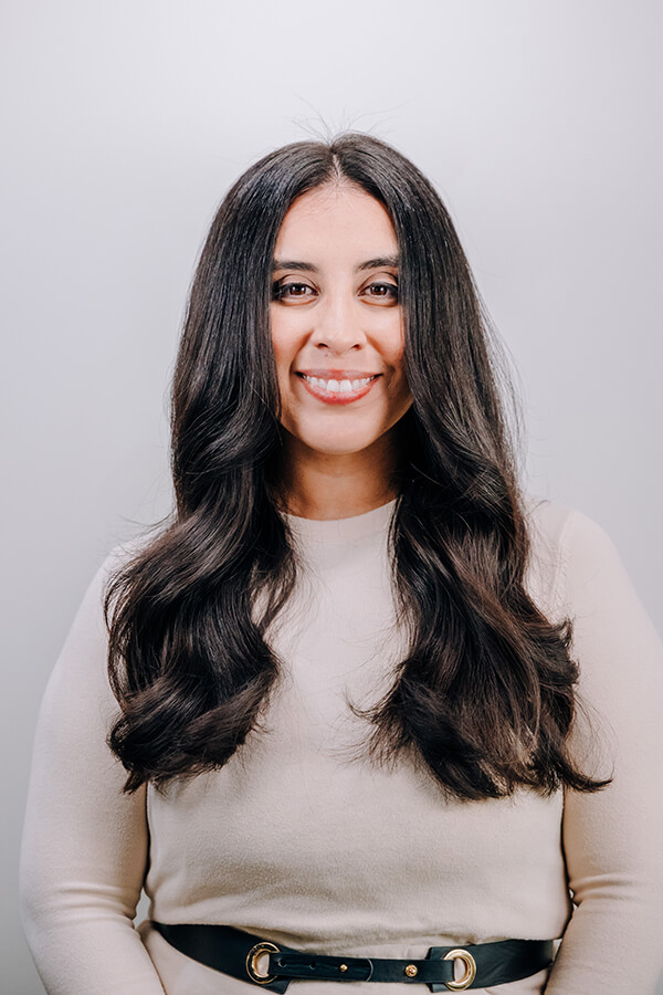 Brunette woman with long hair smiling at camera