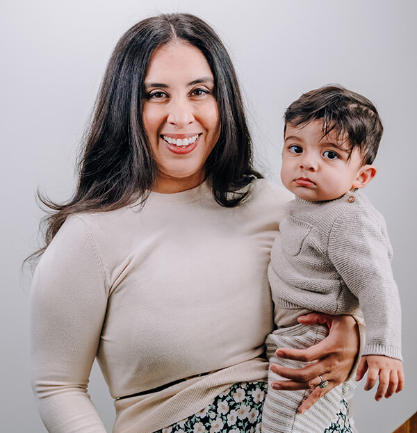 mama-mia-after Woman smiling holding baby on hip