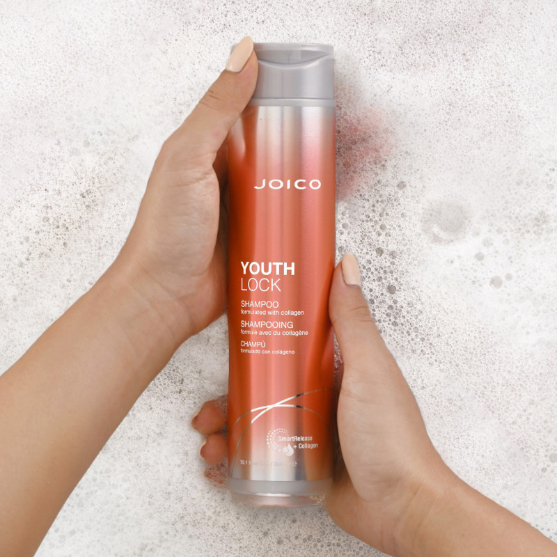 youthlock shampoo in suds with hands holding