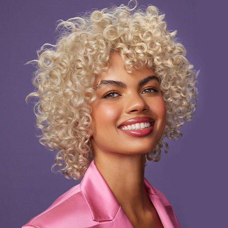 model with blonde curly hair for demi gloss level 12 toners