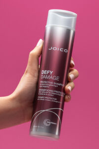 defy damage shampoo in hand
