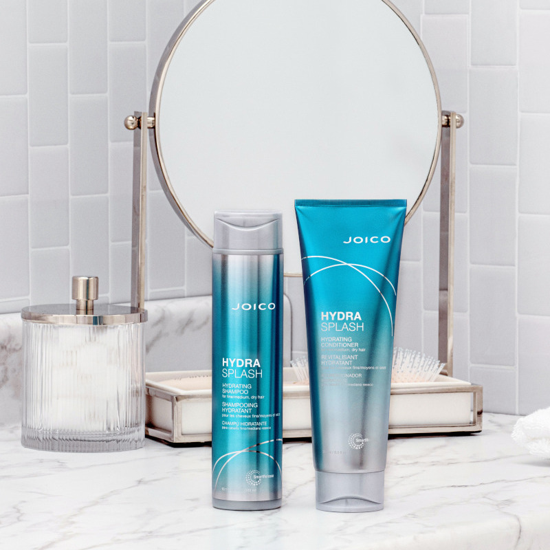 hydrasplash shampoo and conditioner on counter with mirror
