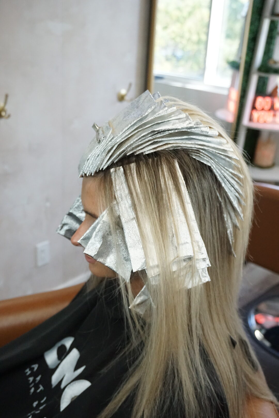 blonde model in chair with foils in hair
