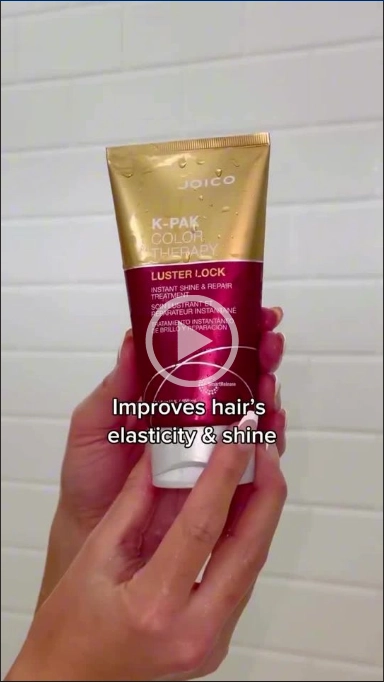 Woman holding luster lock treatment bottle