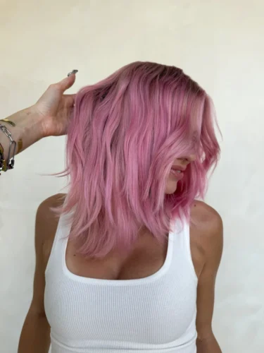 Woman with bright pink hair after dyeing