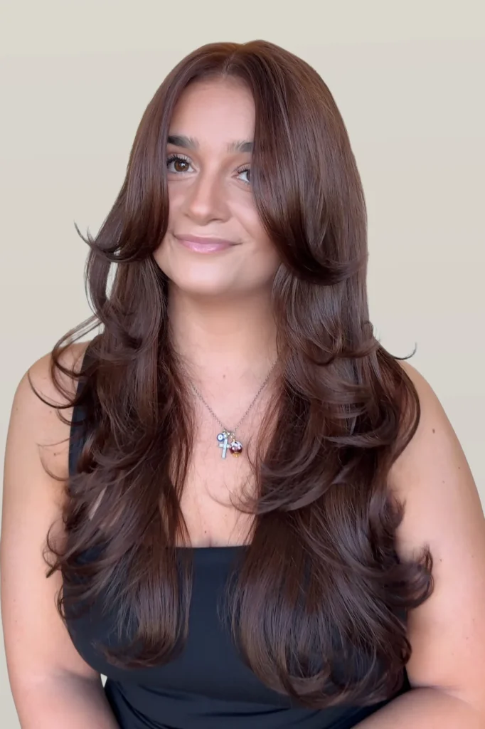 Woman with chocolate brown hair smiling