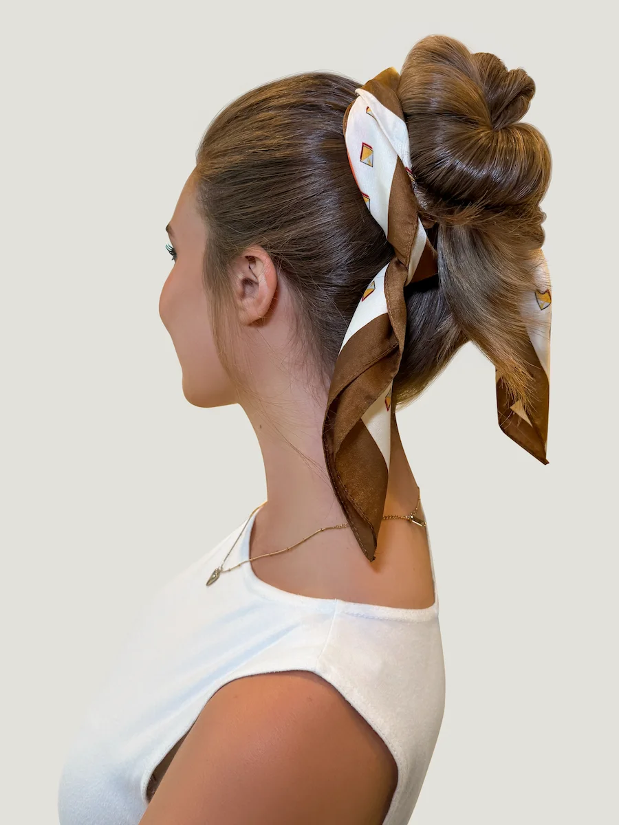 Stylish hair of brunette woman with up do scarf look