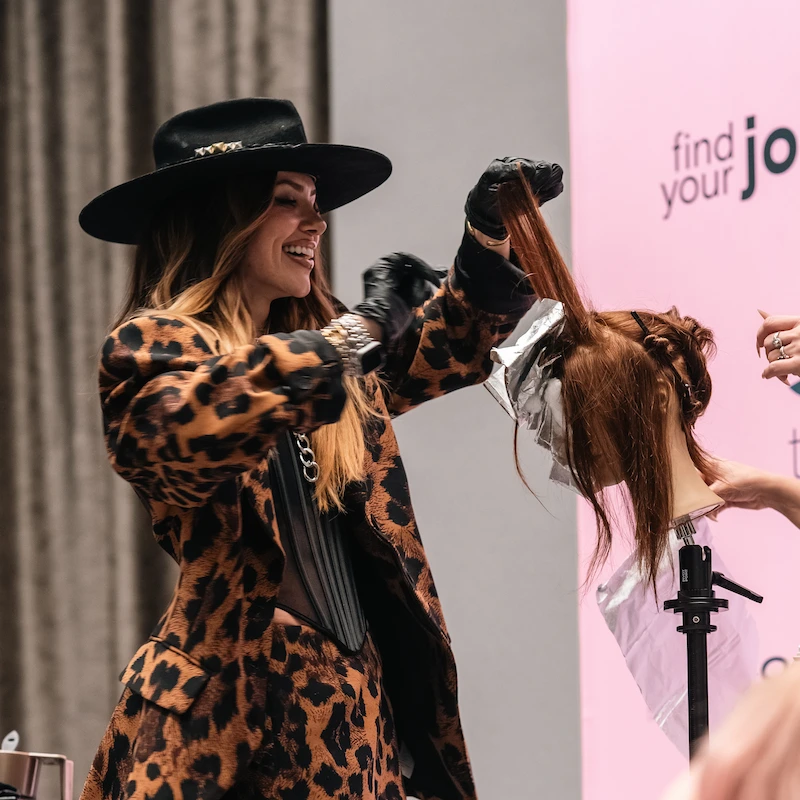 Larisa hair stylist demonstrating techniques in front of audience